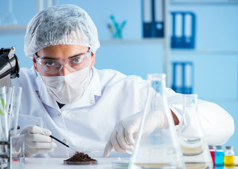 Male scientist researcher doing experiment in a laboratory