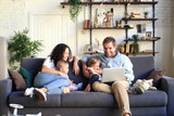Fototapeta Przeznaczenie - Young beautiful happy family relaxing at home