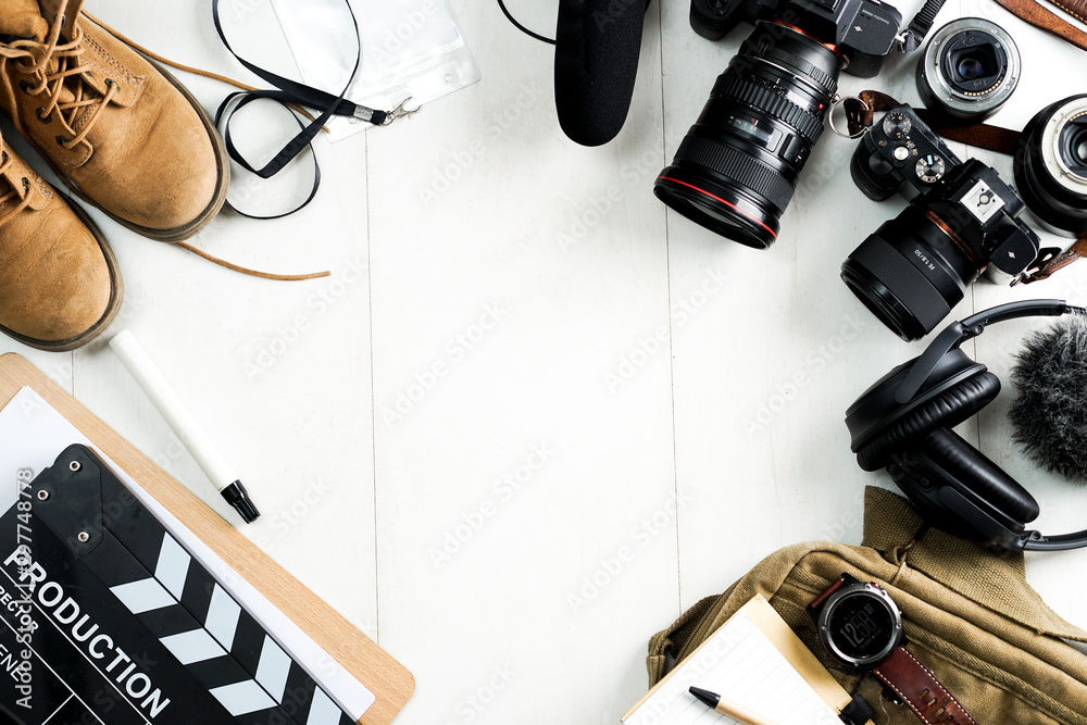 Camping or adventure trip scenery concept. Backpack, boots, belt, thermos and camera on wooden background captured from above (flat lay). Layout with free text (copy) space. - obrazy, fototapety, plakaty 