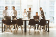 © xartproduction - A team of young businessmen working and communicating together in an office. Corporate businessteam and manager in a meeting.