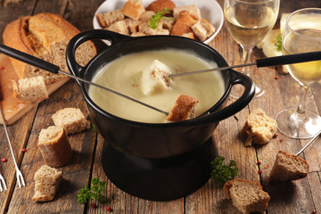 Wall Mural - cheese fondue with wine and bread, top view