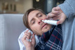 © zinkevych - Blue-eyed man having stuffy nose taking nasal spray