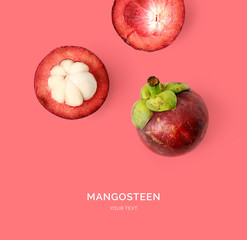 Wall Mural - Creative layout made of mangosteen. Flat lay. Food concept. Mangosteen on the pink background.