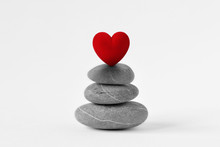 Stacked Zen Stones With Heart On White Background - Concept Of Love And Balance