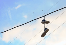 Sports Shoes Dangling On Electric Wires