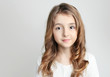 © nys - Caucasian child girl portrait on grey background empty copy space.