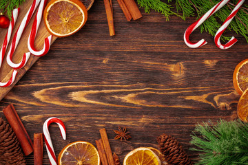 Wall Mural - Christmas background with candy cane on decorated wooden desk