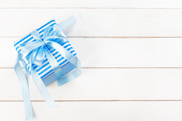 Gift boxes with ribbon on white table close up