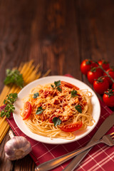 Wall Mural - Pasta carbonara with tomato sauce and minced meat, grated parmesan cheese and fresh parsley - homemade healthy italian pasta on rustic wooden background. 