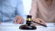 © motortion - Marriage rings and gavel closeup, spouses signing divorce document on background