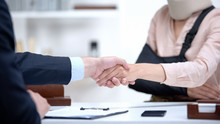 Insurance Agent Shaking Hand With Woman In Arm Sling, Psychological Support