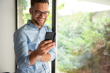 Smiling man texting messages	