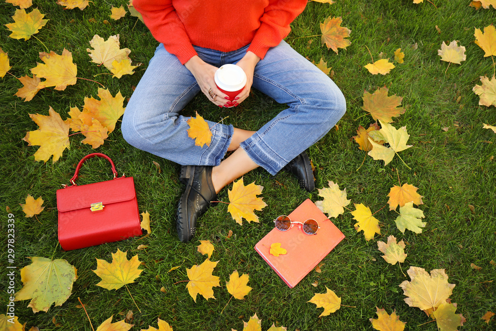 Beautiful young woman resting in autumn park