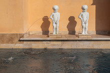 Abstract Image Of Shabby White Statue Or Sculpture Child Standing And Peeing Or Urine Nearly Swimming Pool.