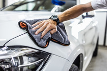A Man Cleaning Car With Microfiber Cloth, Car Detailing (or Valeting) Concept. Selective Focus.