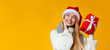 © Prostock-studio - Dreamy girl with christmas gift looking at copy space
