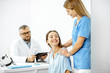 © rh2010 - Nurse supporting young patient during a medical consultation with senior doctor in the white office