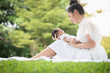 © amornchaijj - Beautiful Asian young mother  or single mom with new born baby girl are doing activities and relaxing in the park. concept of duties of wife and mother in raising children and family.