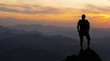 © poliki - man on top at sunset surrounded by mountains