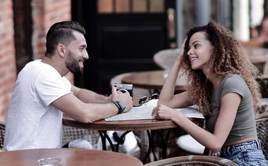 Canvas Print - Beautiful loving couple sitting in a cafe enjoying in coffee