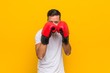© Asier - Young south-asian boxer man wearing red gloves.