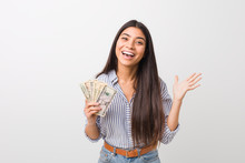 Young Arab Woman Holding Dollars Celebrating A Victory Or Success
