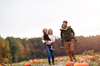 © pikselstock - Happy young family in pumpkin patch field