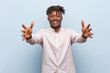 © Asier - Young business african black man feels confident giving a hug to the camera.