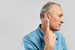© amixstudio - Portrait of middle aged caucasian man in profile pointig finger on his ear isolated on white with copy space. Senile hearing loss concept