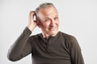 © amixstudio - Stylish elderly middle-aged man scratches his head and thinking isolated in white studio, itching and discomfort of the scalp, dandruff