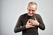 © amixstudio - Old man grabbed a sick heart isolated on white background, heart attack or stroke, senile disease concept