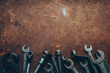 Garage essential instruments. Professional wrench set on rusty dark metal background. Copy space.