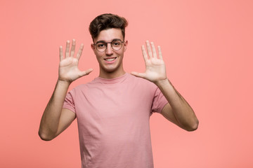 Wall Mural - Young cool caucasian man showing number ten with hands.