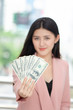 © Mrzproducer - Beauitful young asian woman handing over money