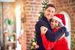 © Krakenimages.com - Young beautiful couple smiling happy and confident. Standing and hugging around christmas tree at home