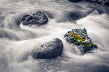 Long Exposure Of Water Flowing Over Rocks In Stream,