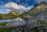 Fototapeta Do pokoju - Amazing Landscape in Bulgarian mountain, reflection of the sky in the lake and tents around the lake at Rila mountain in Bulgaria.