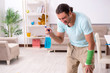 © Elnur - Young injured man cleaning the house