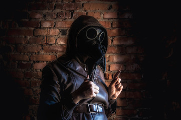 Wall Mural - Terrible plague doctor on red brick background. Masked maniac with scalpel and scissors. Halloween and horror