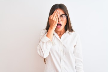 Poster - Young beautiful businesswoman wearing glasses standing over isolated white background Yawning tired covering half face, eye and mouth with hand. Face hurts in pain.