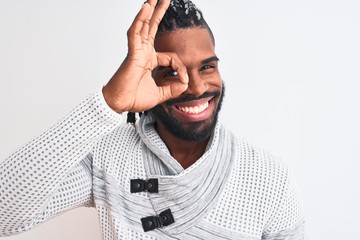 African american man with braids wearing grey sweater over isolated white background with happy face smiling doing ok sign with hand on eye looking through fingers