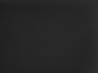 Dark grainy texture. Black foam rubber background