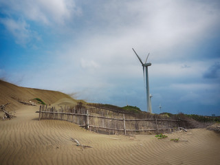 Beautiful dune and windmill in the beach dunes hill at Guanyin, Taiwan   