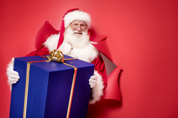 Wall Mural - Santa Claus with the big gift box.