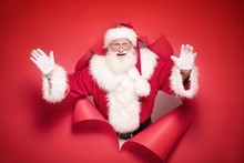 Emotional Santa Claus On The Red Background.