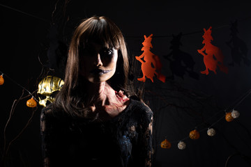 Devil White face clown and Zombie girl black hair, two ghosts possessed together over Halloween backgrounds with witches and pumpkins head decorate die tree, low key dark shadow exposure copy space