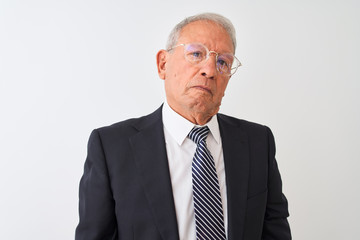 Sticker - Senior grey-haired businessman wearing suit and glasses over isolated white background with serious expression on face. Simple and natural looking at the camera.