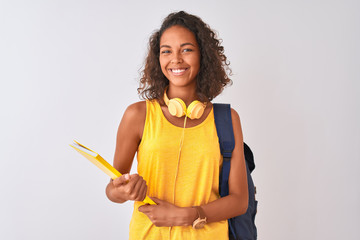 Brazilian student woman wearing backpack holding notebook over isolated white background with a happy face standing and smiling with a confident smile showing teeth