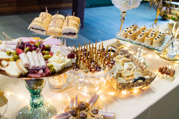 fancy elegant desert table with lot of sweets and candies.