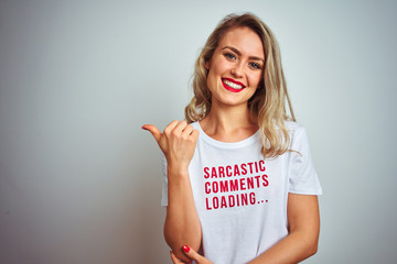 Beautiful woman wearing sacarstic comments loading t-shirt over isolated background smiling with happy face looking and pointing to the side with thumb up.